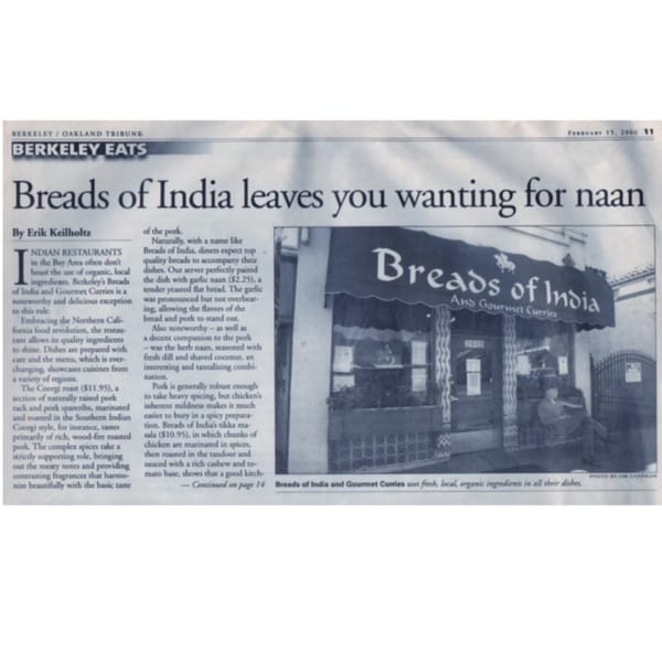 Newspaper article featuring a review of "Breads of India and Gourmet Curries" restaurant, with a photo of its storefront.
